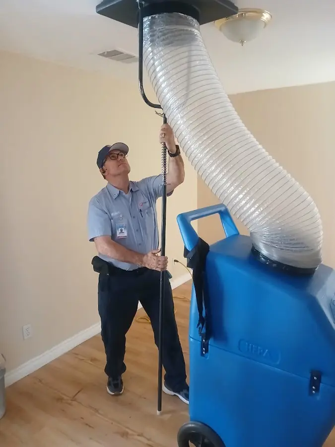 Furnace Tune-Up technician using HEPA equipment in Chisago City